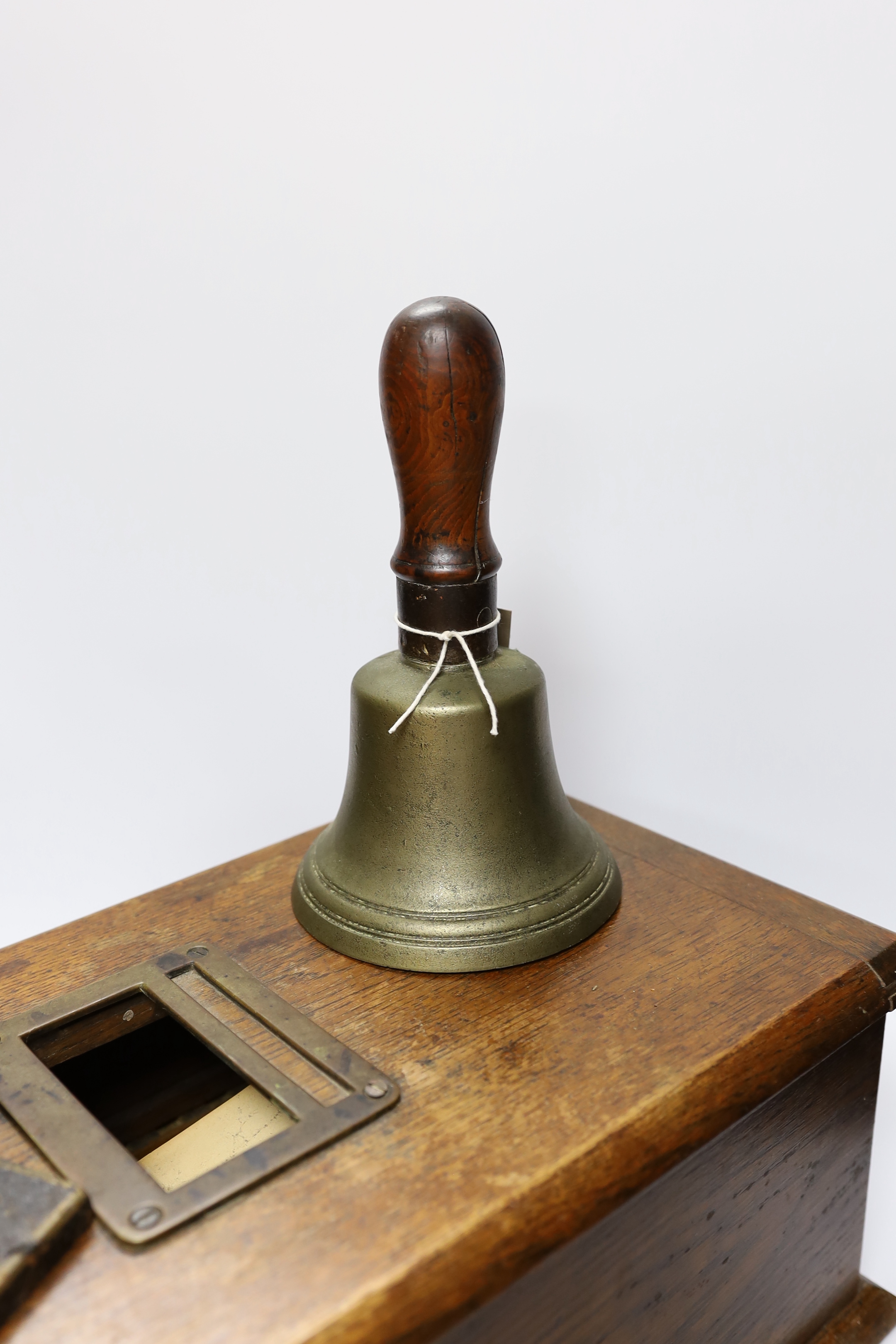A Victorian oak Till and Company paper stamp from Alex Rice Ltd, formerly Fisher St., Lewes, and a Victorian handbell, largest 46cm wide (3)